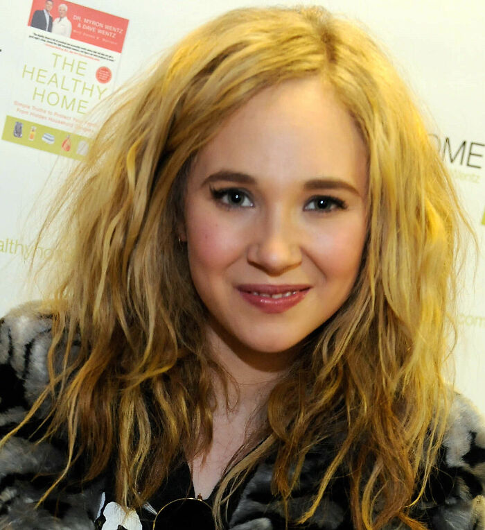 Juno Temple career highlights: a close-up of Juno Temple with wavy blonde hair and a striped top, smiling slightly.