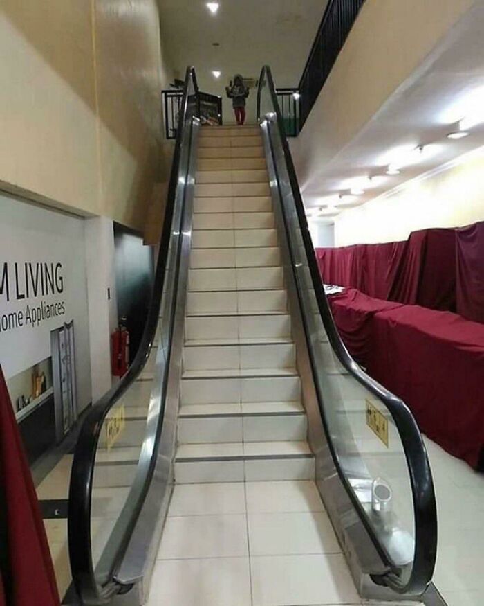 An escalator with steps that dont move, highlighting a major construction fail in public infrastructure.