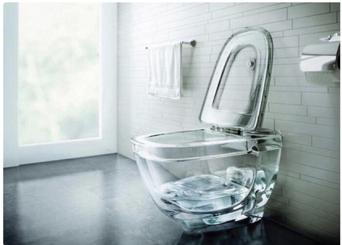 A clear glass toilet in a modern bathroom, not necessarily a construction fail but an unusual design.