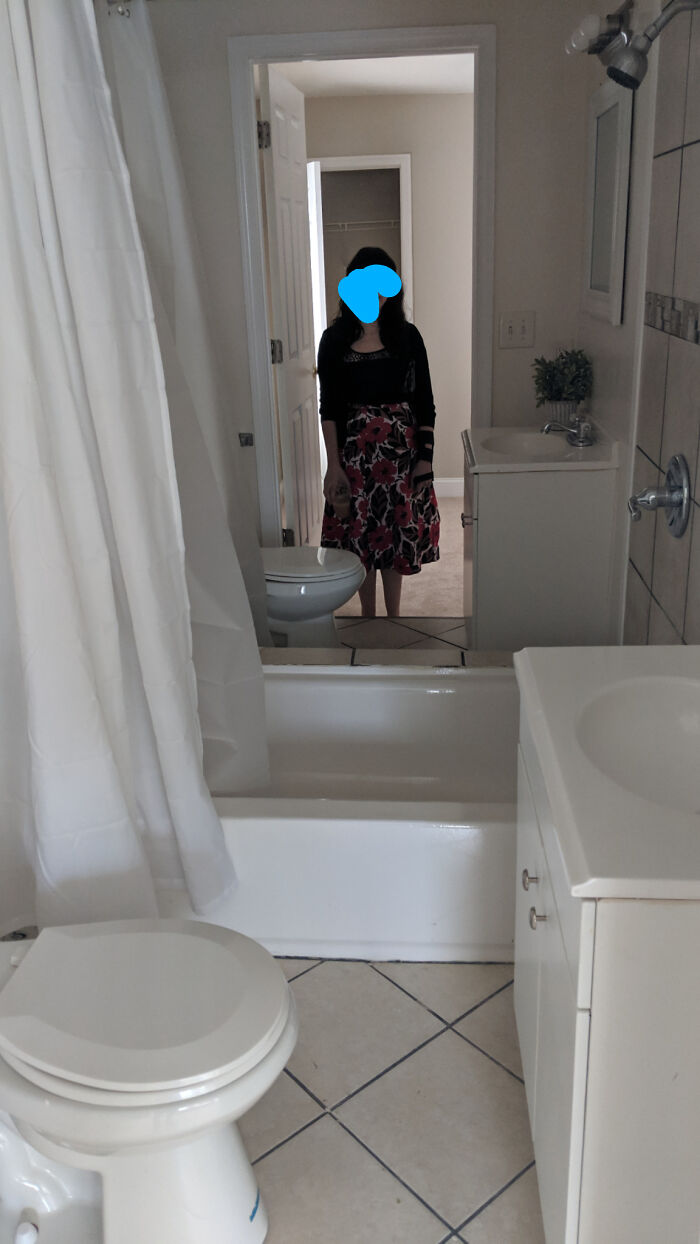 A bathroom with a toilet placed unusually close to the bathtub, demonstrating construction fails.