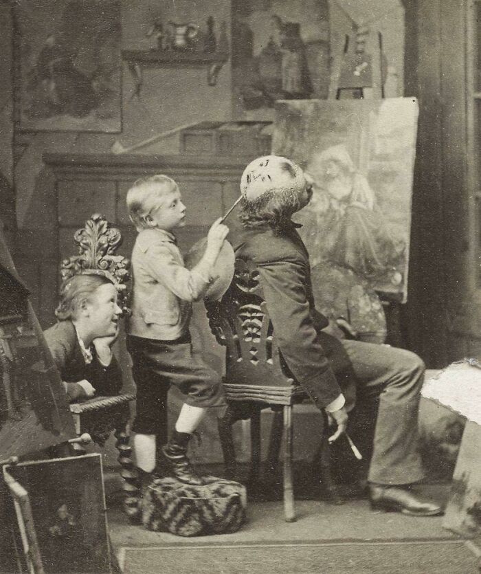 Historical photos: Two children painting an adult's head, an endearing scene from the past.