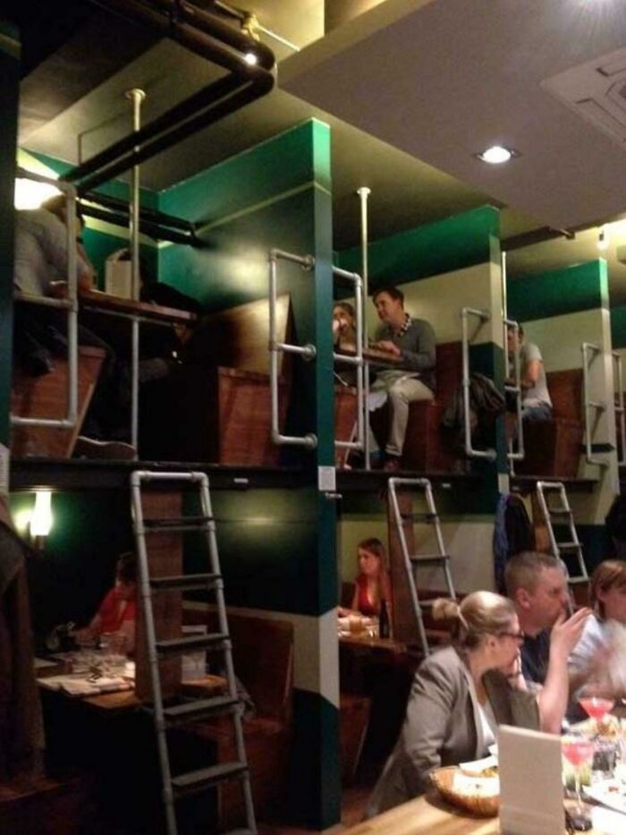 A restaurant with multiple levels of seating, accessed by ladders, a clear construction fail.
