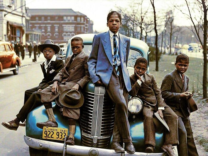 Five young boys in stylish suits pose on and around a vintage car with an Illinois 1941 license plate, in historical photos.