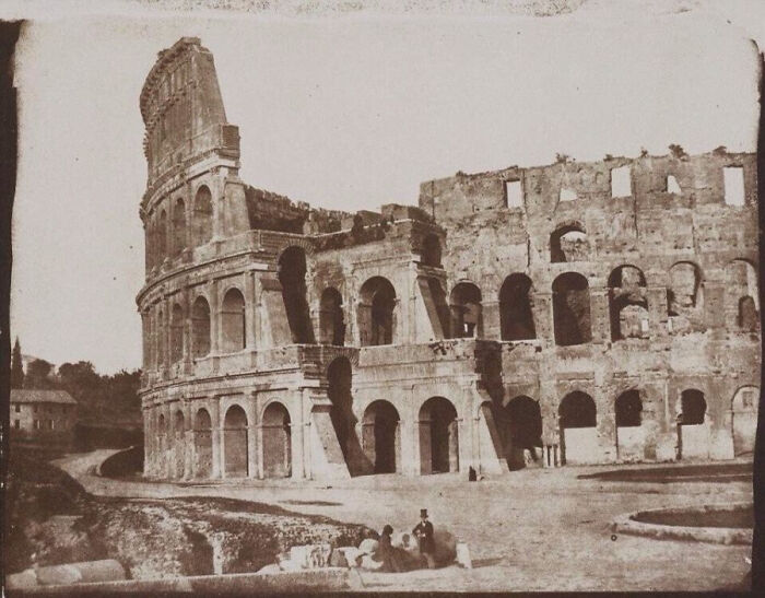 A historical photo of the Colosseum in Rome, showing its ancient ruins and preserving a piece of the past.