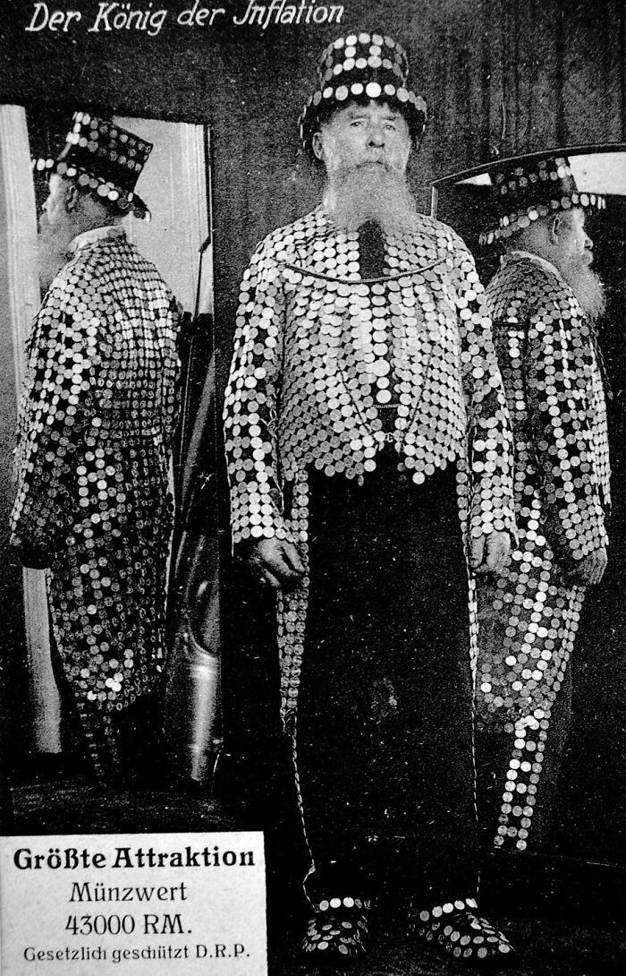 A historical photo showing a man in a suit adorned with coins, reflecting the past during inflation.