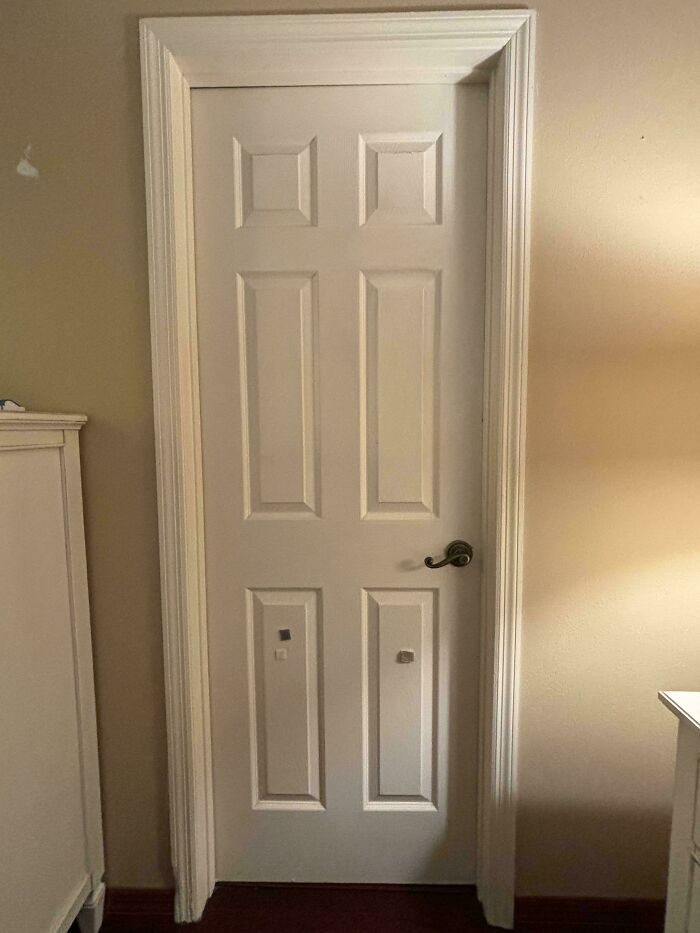A white door with apparent damage and marks, an example of problems people ask for help fixing.