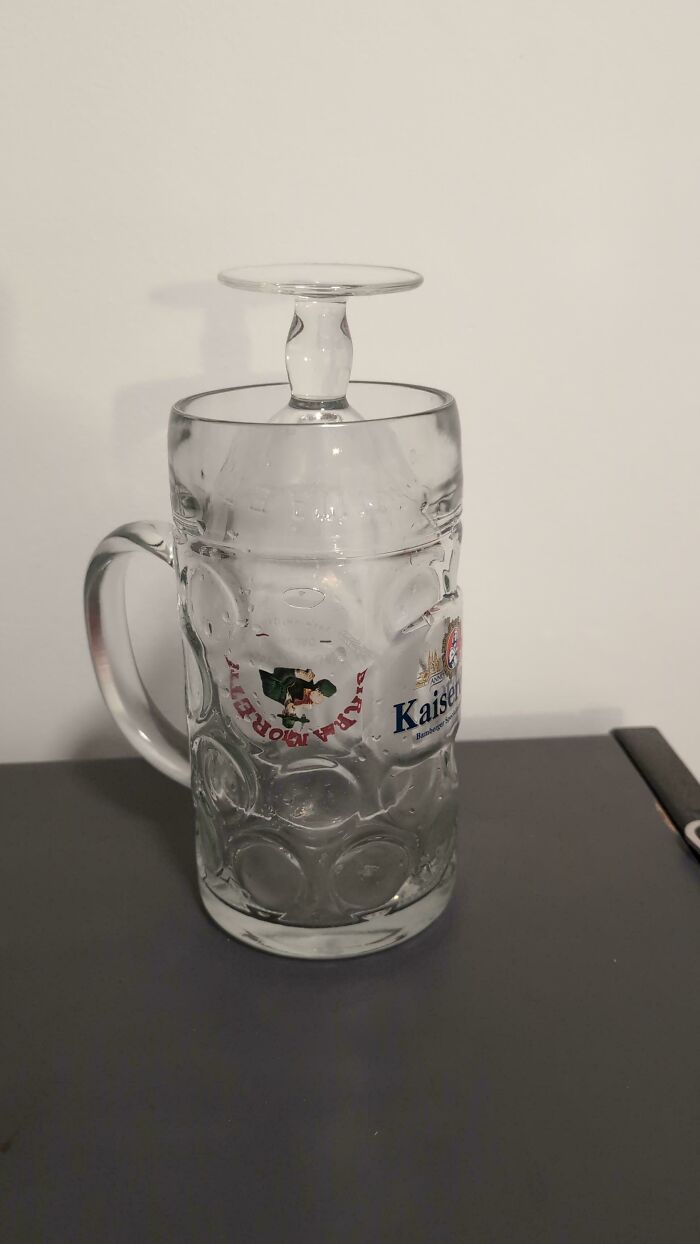 A large, clear beer stein with a smaller glass inverted and placed on its top, showcasing creative problem solving for fixing things.