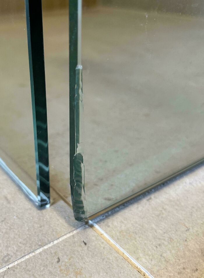 A close-up shot of a cracked glass panel, showing damage that needs fixing.