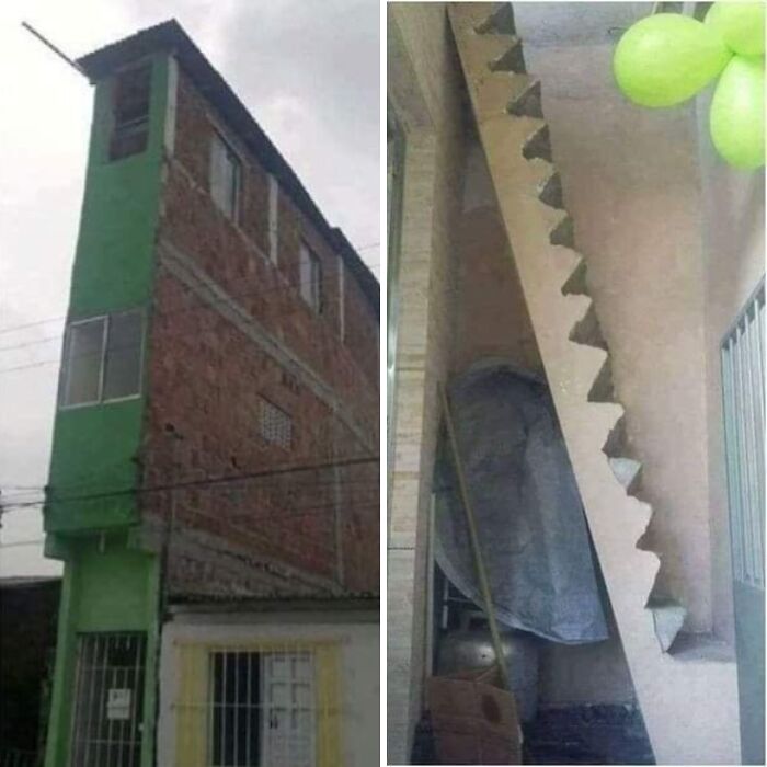 A narrow green and brick building next to stairs that lead to a wall, highlighting construction fails.