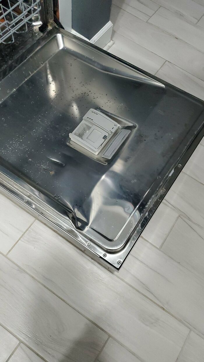 An open dishwasher door, showcasing a household item that might need help fixing problems.