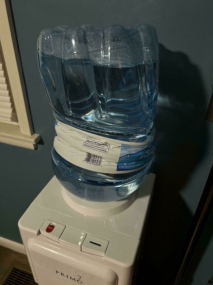 A distorted water bottle on a dispenser, highlighting the need for help fixing things.
