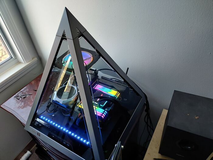 A pyramid-shaped PC case with brilliant RGB lighting, an enjoyable design transforming an ordinary computer.