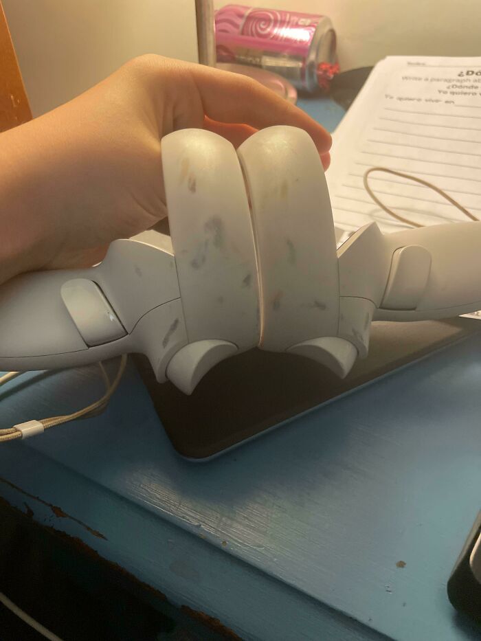 A pair of dirty white VR controllers, showing someone having a worse day than you.