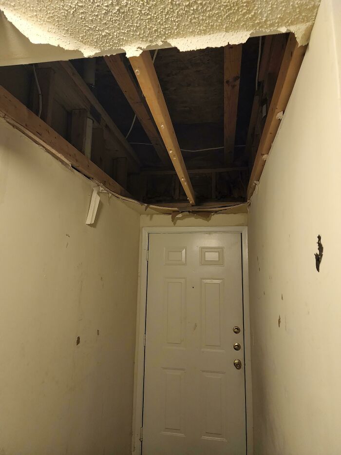A ceiling has collapsed over a doorway. Someone is having a worse day.