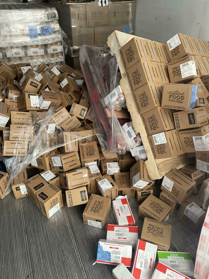 A large pile of fallen boxes in a warehouse, having a worse day than you.