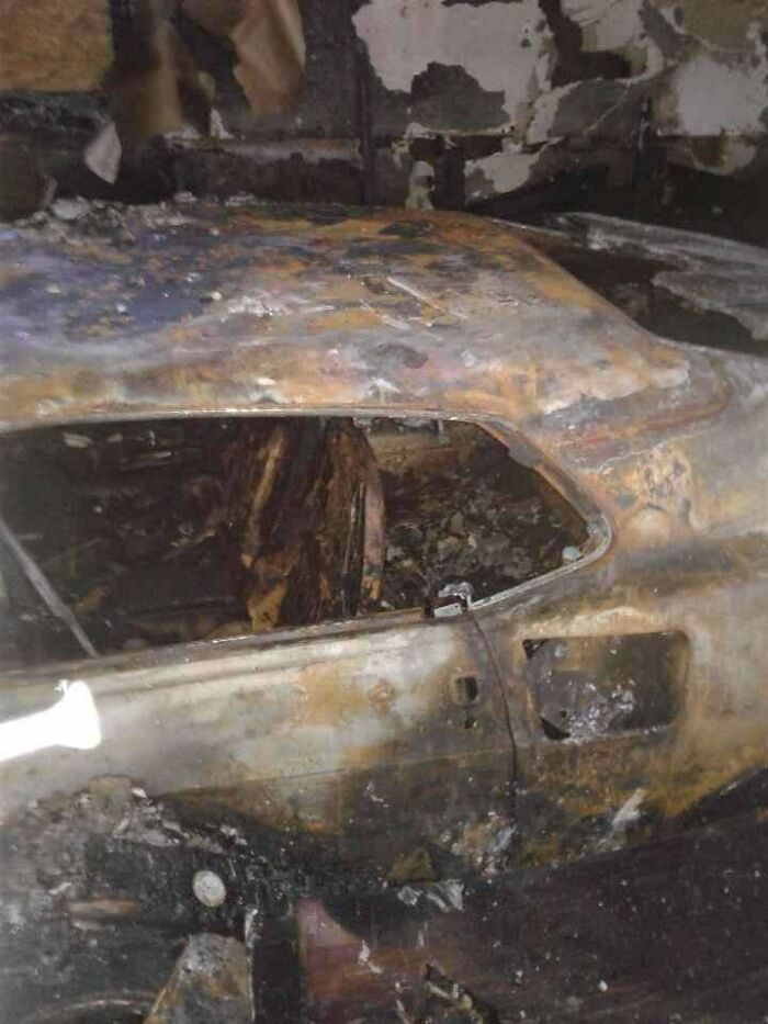 The charred remains of a car interior after a fire, showing a way worse day for the owner.
