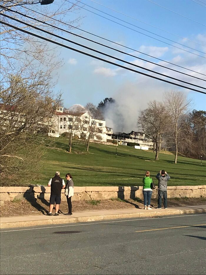 People watching a building on fire, having a worse day.