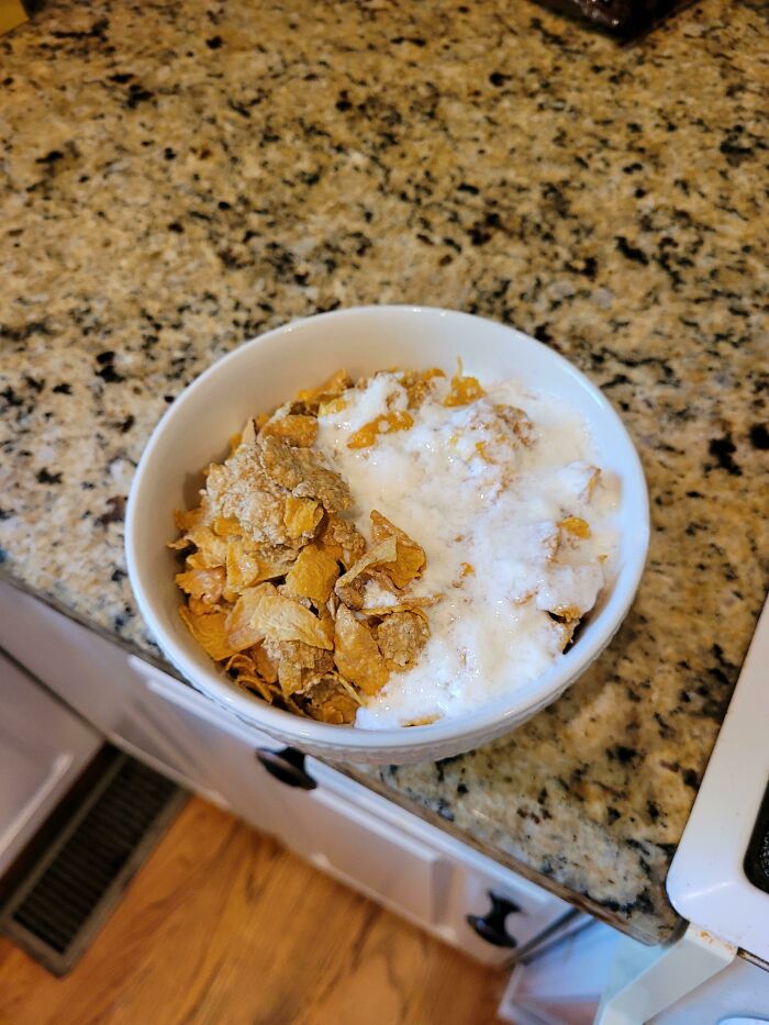 A bowl of cereal with soggy flakes and milk, clearly having a worse day.