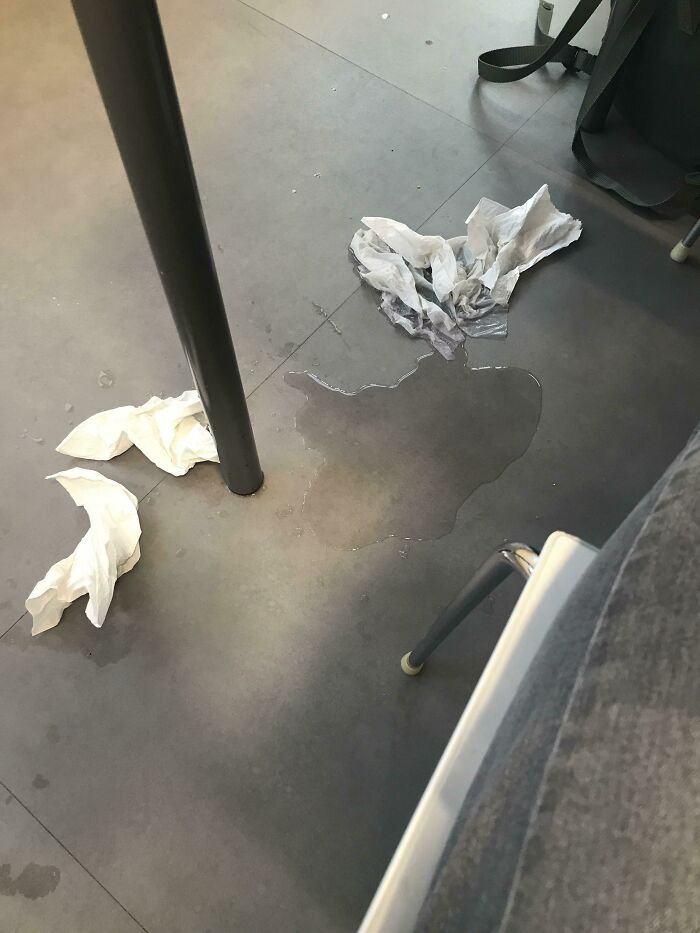 Spilled water and crumpled tissues on the floor, suggesting someone had a worse day.