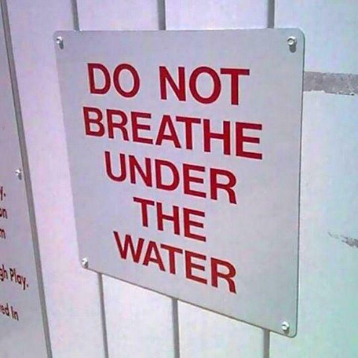 A hilariously failed sign reading DO NOT BREATHE UNDER THE WATER.