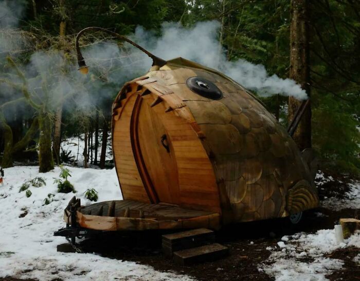 A unique fish-shaped cabin in a snowy forest, transformed brilliantly for an enjoyable escape.