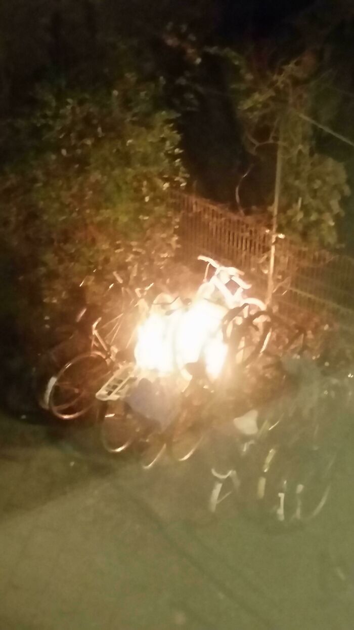 A blurry, nighttime image of a group of bicycles engulfed in flames, symbolizing people having a worse day.