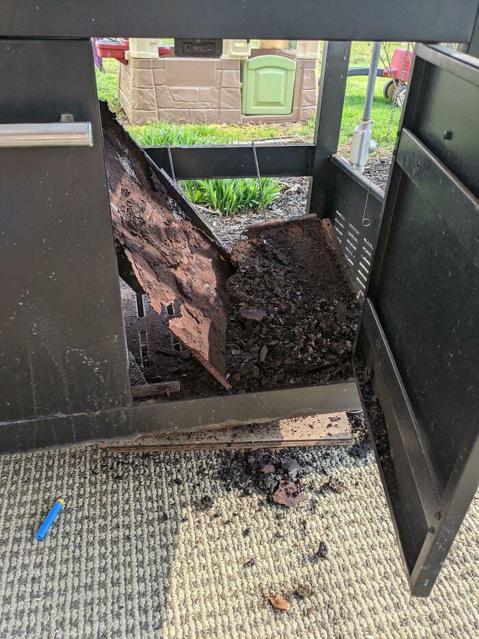 A damaged grill with a collapsed interior, showing a person having a worse day.