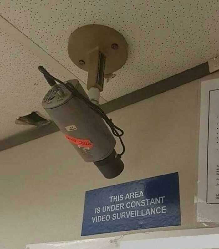 A hilariously failed sign states constant video surveillance below a camera pointed at the ceiling.