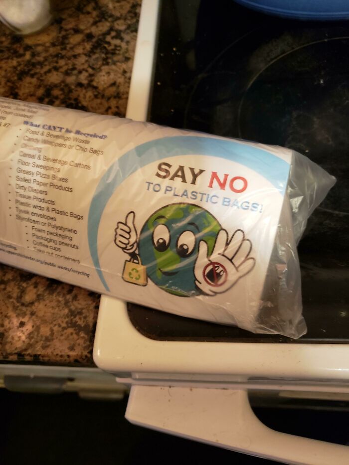 A roll of plastic bags with a 'Say no to plastic bags' label, a hilarious sign failure.