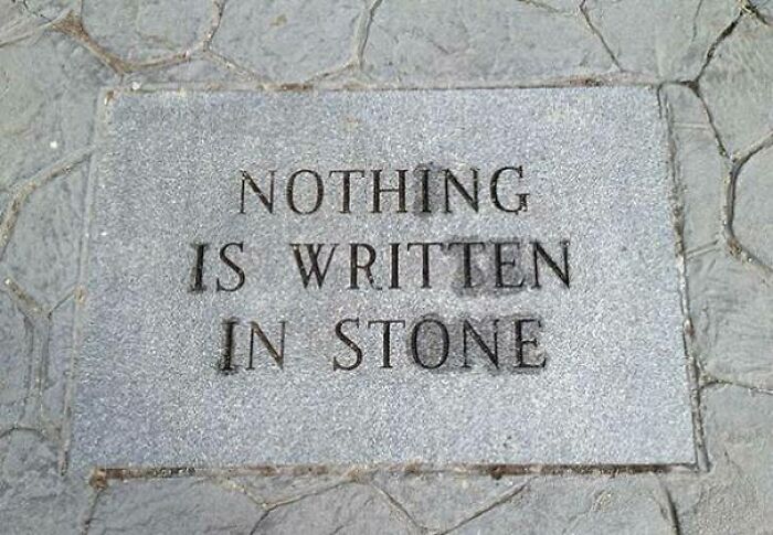 A stone slab engraved with NOTHING IS WRITTEN IN STONE, a sign that hilariously failed its own statement.
