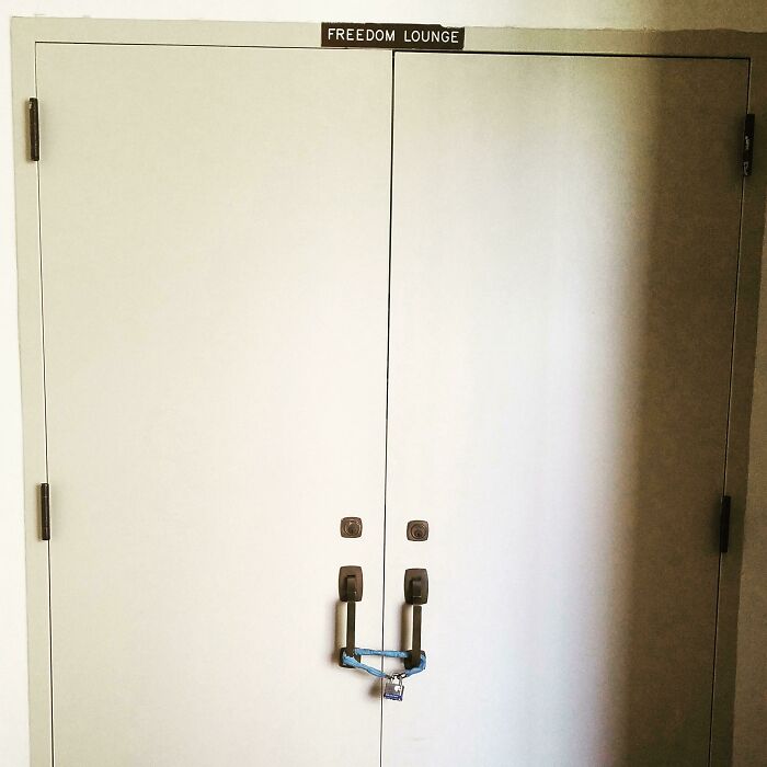 A locked double door with a Freedom Lounge sign above, a sign that hilariously failed at its purpose.