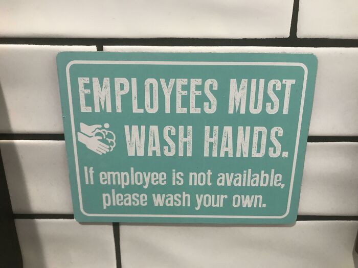 A sign on a tiled wall stating EMPLOYEES MUST WASH HANDS and If employee is not available, please wash your own, hilariously failed at instruction.