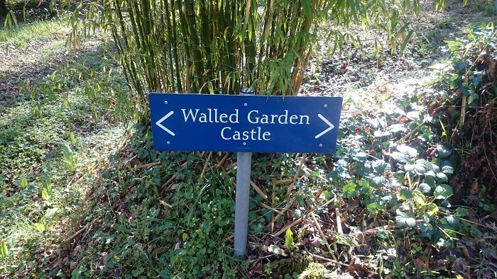 A hilariously failed sign pointing in both directions towards a Walled Garden Castle.