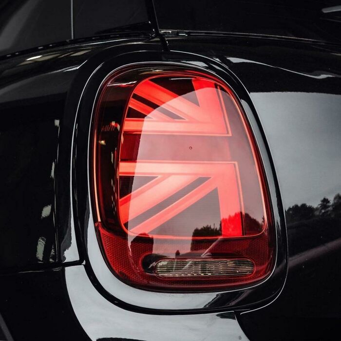 A Mini Cooper taillight brilliantly designed to display the Union Jack flag, transforming ordinary car lights into something more enjoyable.