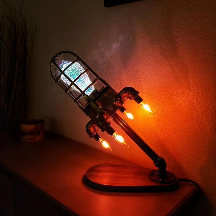 A steampunk rocket lamp with glowing thrusters, a brilliant design transforming an ordinary lamp into something more enjoyable.