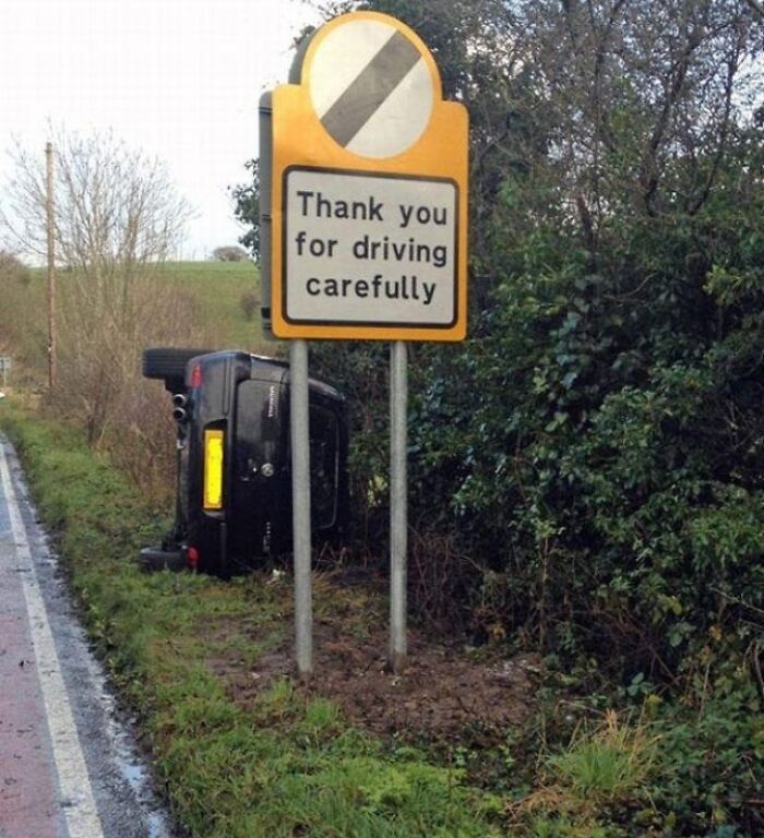 An overturned car next to a sign that says 'Thank you for driving carefully', a hilarious sign failure.