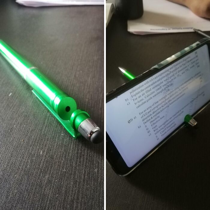 Green pen transformed into a phone stand, cleverly holding a smartphone displaying text, showcasing brilliant design.