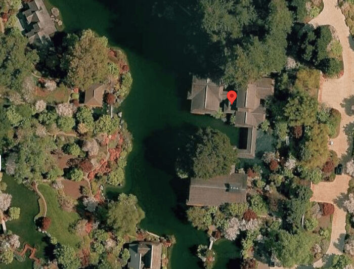 Aerial view of a home surrounded by water, exemplifying a chaotic good situation.