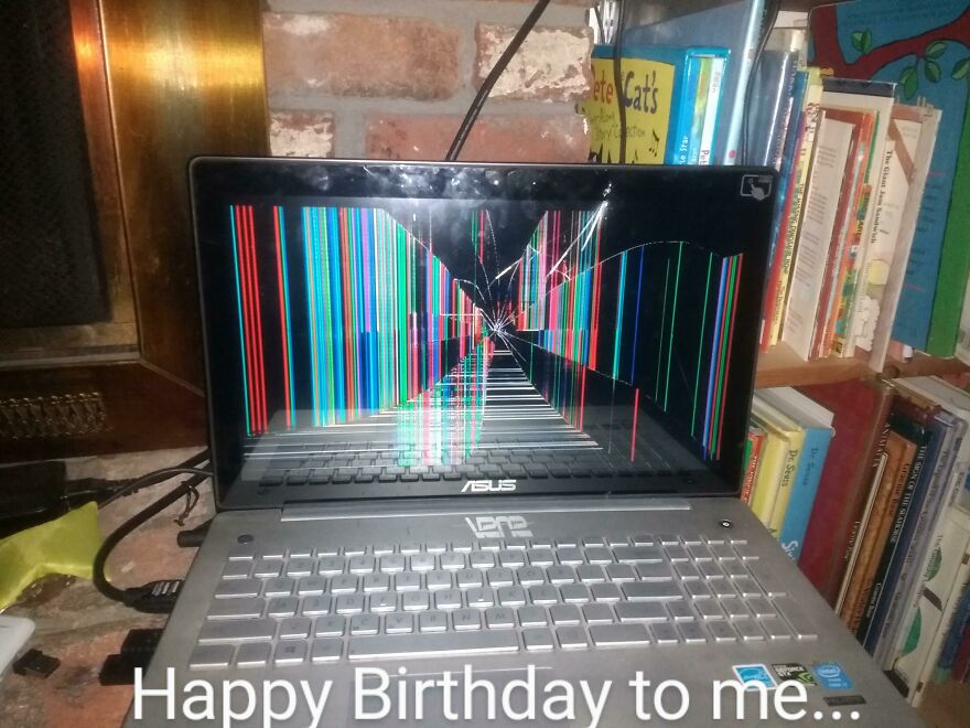 An expensive mistake: a laptop with a shattered screen displays colorful, distorted lines.
