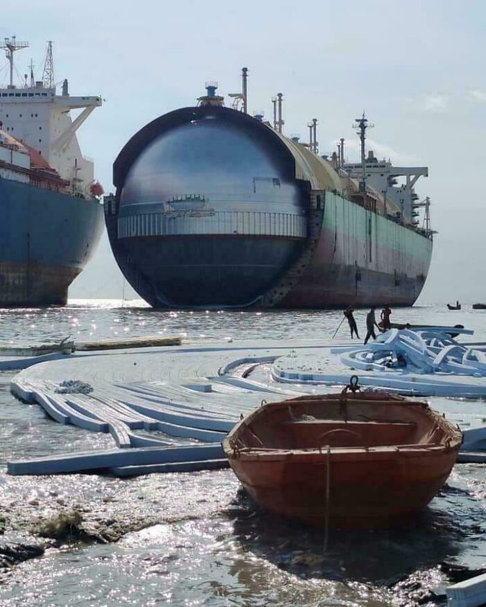 Massive ships with enormous gas tanks on the water, highlighting the true scale of marine vessels.