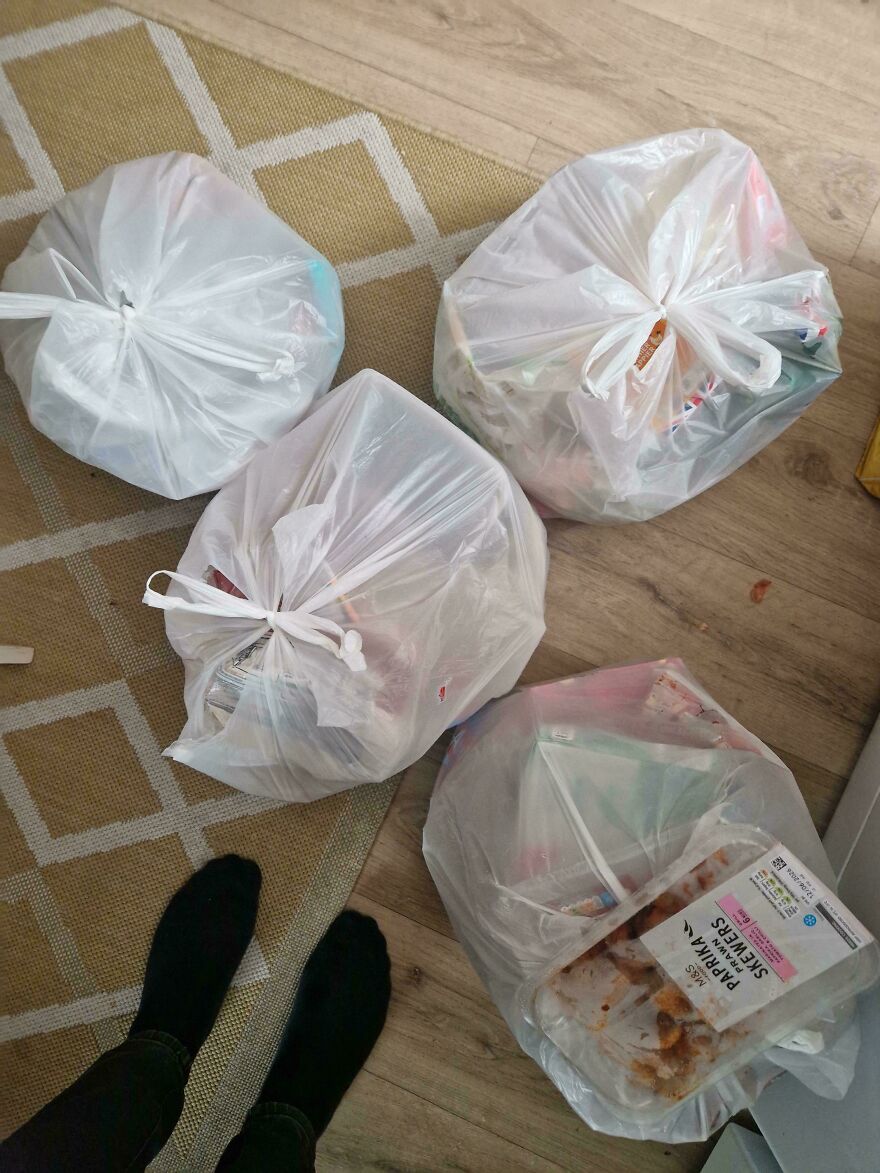 An expensive mistake: Four white plastic bags of trash sitting on a patterned rug, a common accident.