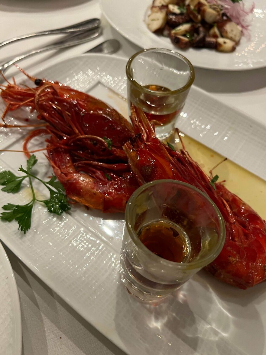 Large cooked prawns with two small glasses of liquid and a cheese slice, avoiding an expensive mistake with this delicious meal.