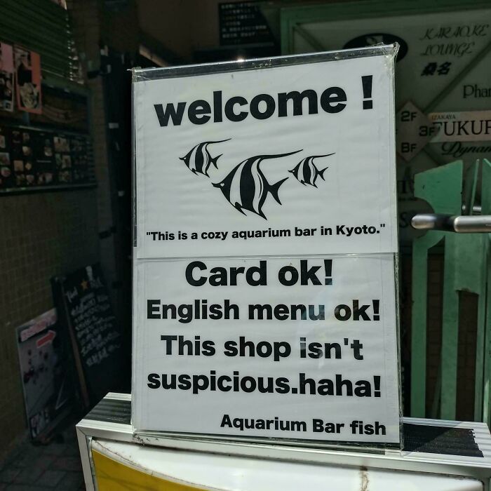 An oddly specific welcome sign for a Kyoto aquarium bar, stating it is not suspicious.