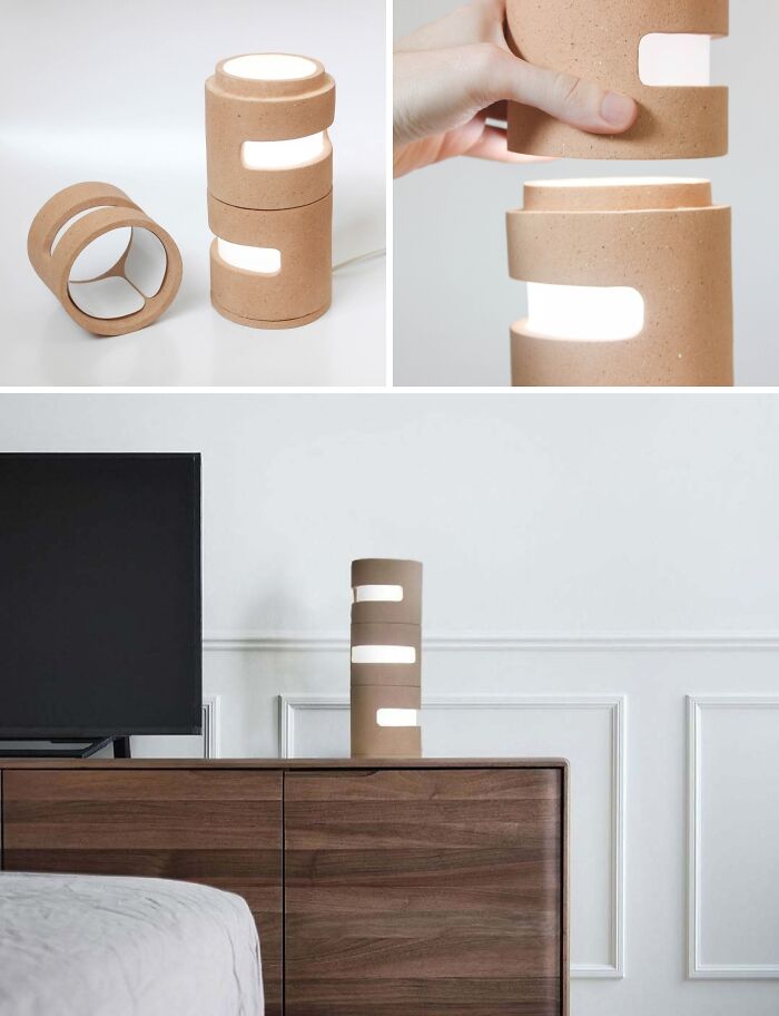 A stacked cylindrical lamp with brilliant design choices, providing adjustable lighting on a wooden dresser.