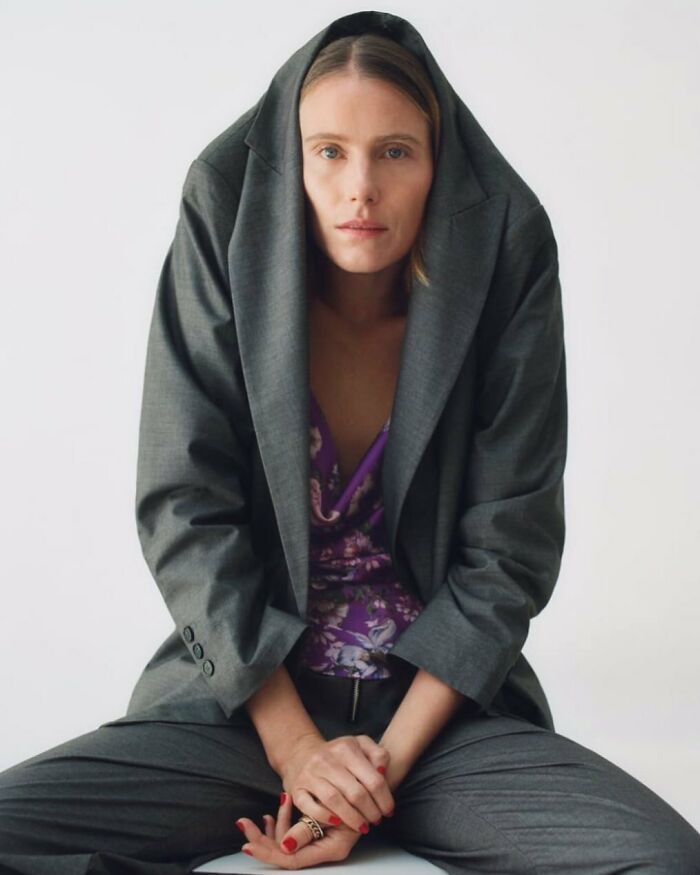 A model wearing a grey suit jacket as a hood, representing bizarre content from the Zara website.