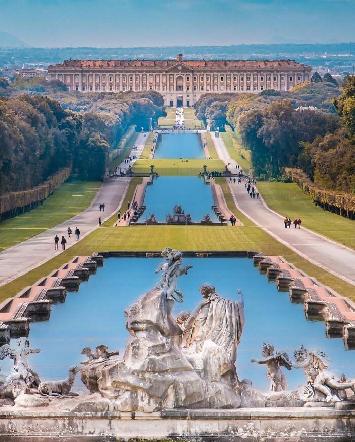 A brilliant design choice shows a grand palace with long water features and statues leading to it, surprising people.