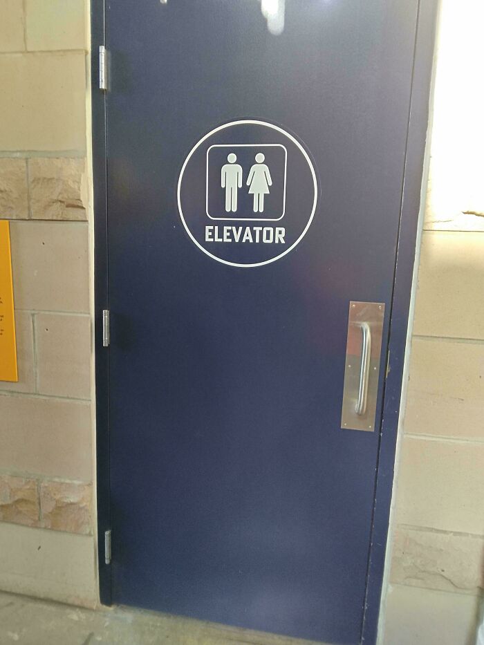 A hilariously awful design fail: a blue door with a sign indicating it is an elevator, but it is a solid door.