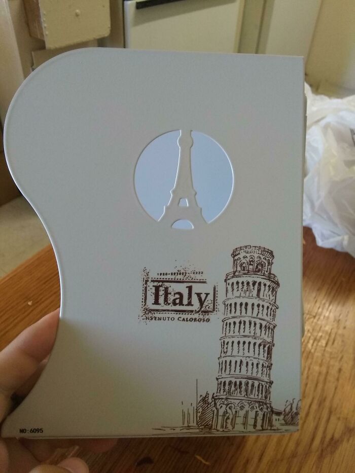 An awful design fail showing a souvenir from Italy with the Eiffel Tower cut out, mixing landmarks.