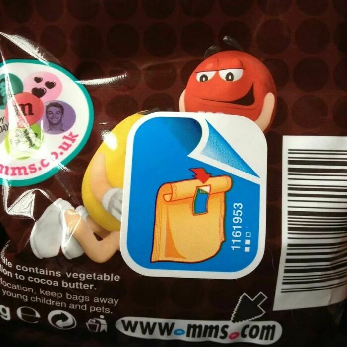 A bag of M&Ms with an instruction sticker, highlighting an awful design fail.
