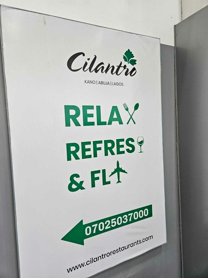 A white sign with green text and a phone number, an awful design fail for a restaurant.